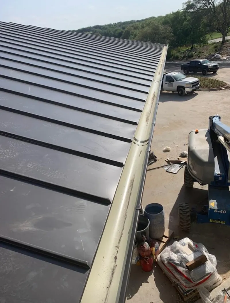 Standing seam panel and gutter detail on a metal roofing jobsite in Prescott Valley